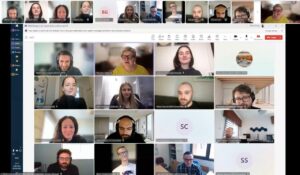 An online meeting held in Miscrosoft Teams where the faces of different participants can be seen