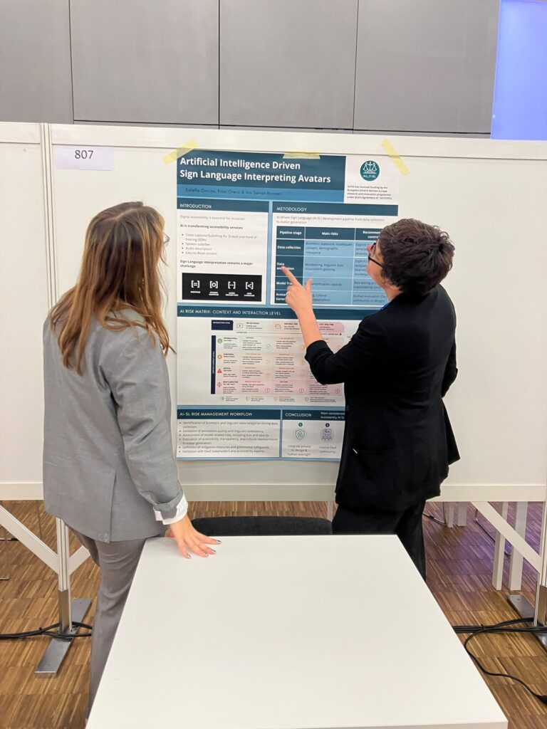 Dr. Estella Oncins and a colleague reviewing a research poster on "Artificial Intelligence Driven Sign Language Interpreting Avatars" during an academic conference exhibition.