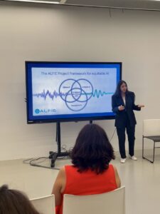 Here is a short alt text in English: > Reyhaneh presenting a slide titled "The ALFIE Project framework for equitable AI," featuring a Venn diagram with pillars for Ethical AI, Inclusive AI, and Transparent AI.