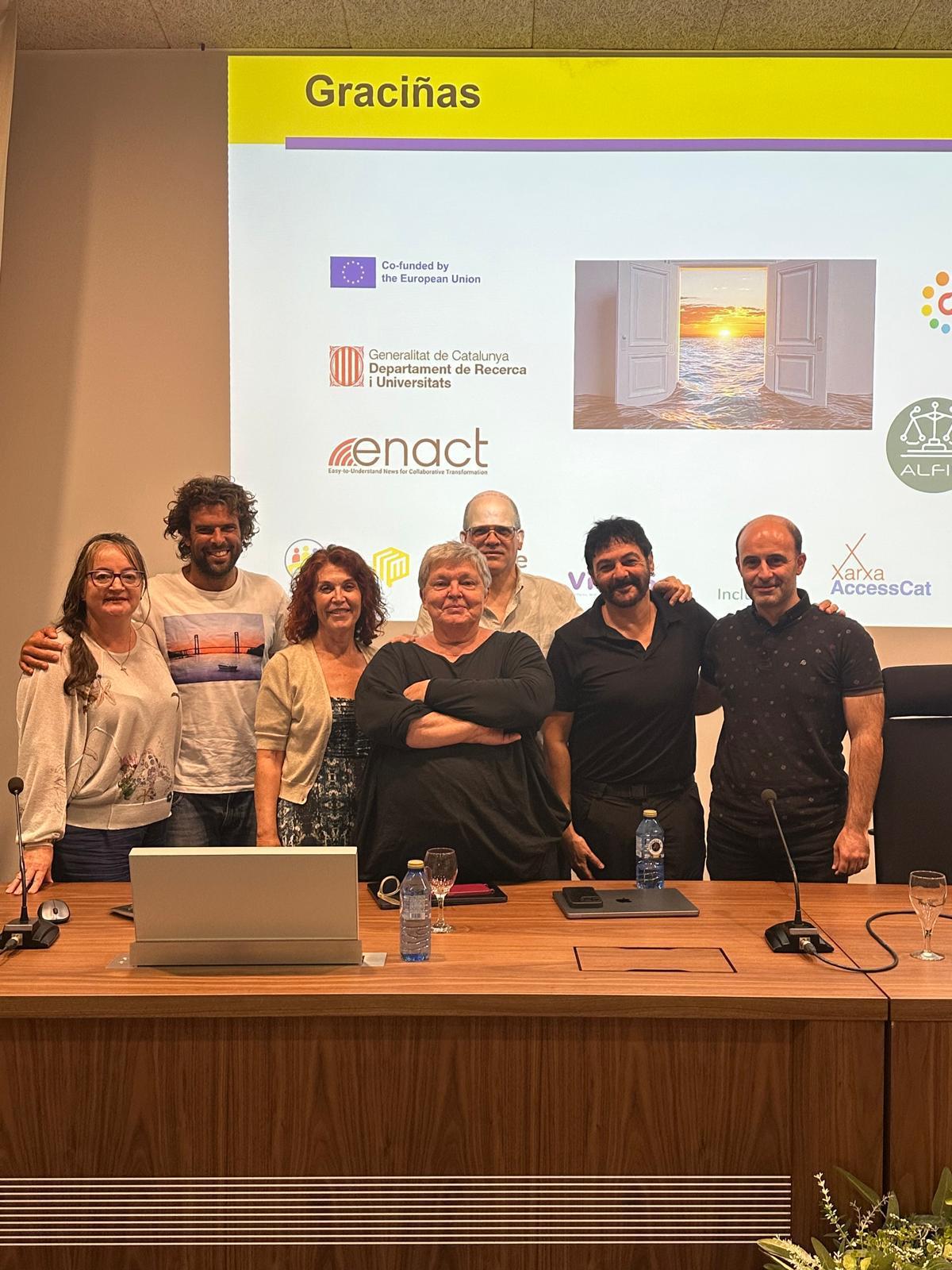 A group of speakers smiling at the camera